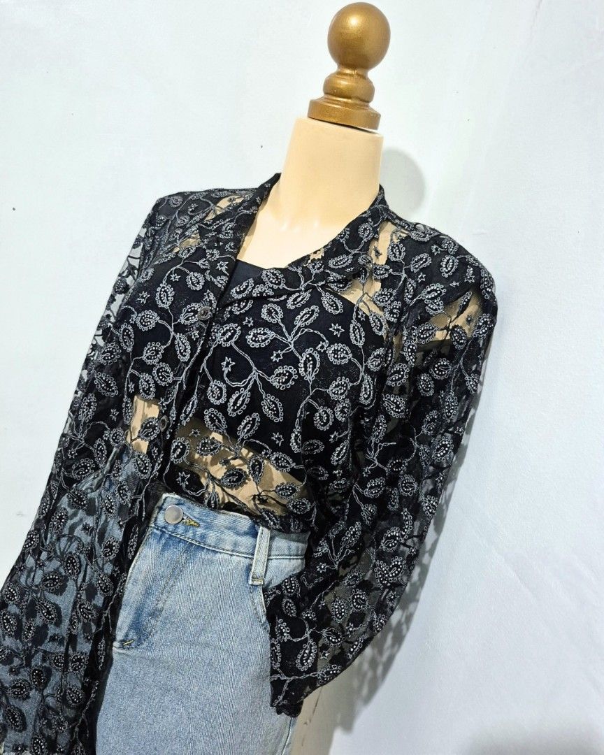 Black Silver Floral Lace Button-Down Top | L–XL (Category: Longsleeves) located in Cabanatuan. Submitted by _erboutique (Listing ID 1466677461, Image 2). Description: • Stunning black lace with silver floral embroidery — so chic & unique ✨ • Collared, button front, sheer statement piece • Pair it with a camisole or bralette underneath • Size L–XL | Shoulder 19" | Bust 44" | Length 28" • Great condition, perfect for dressing up.