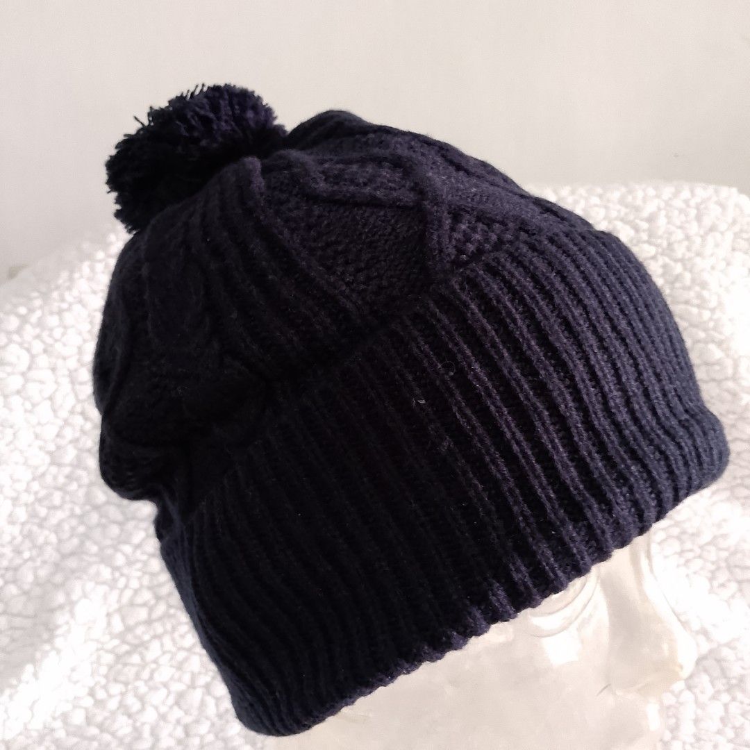Uniqlo Black Cable Knit Beanie Hat (Category: Hats & Beanies) located in Tuguegarao City. Submitted by thriftedtreasures101.1 (Listing ID 1466771032, Image 3). Description: It features a folded ribbed brim and a traditional mixed cable and diamond textured pattern across the crown. The wide ribbed brim folds up to provide extra warmth around the ears. Slightly used, in good condition. Fabric: Polyester and Wool Size: One Size (Adult / Unisex Fit)