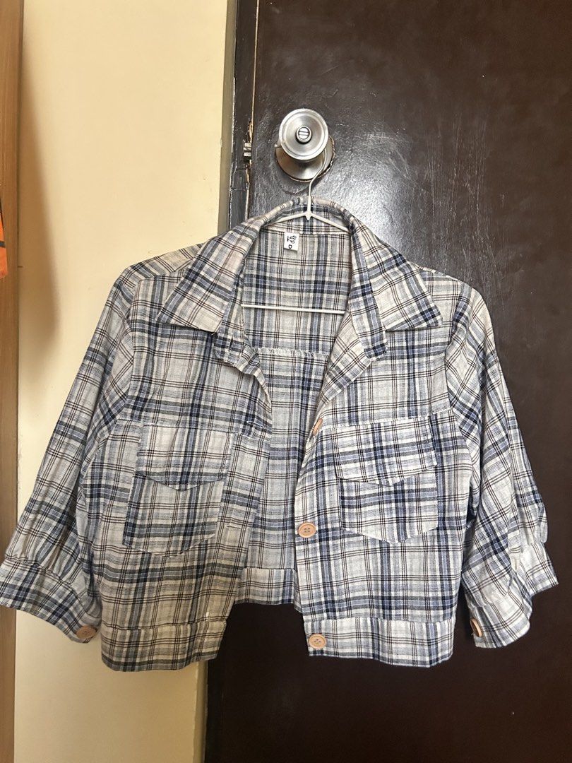 Blue and White Plaid Button-Up Crop Top (Category: Blouses) located in General Mariano Alvarez. Submitted by mochiii_72 (Listing ID 1466606736, Image 1). Description: - Classic blue and white plaid pattern - Trendy cropped length that hits at the waist - Three-quarter sleeves and classic collar neckline - Front button closure with charming wooden-style buttons - Features dual chest pockets - Lightweight fabric, ideal for solo wear or layering.