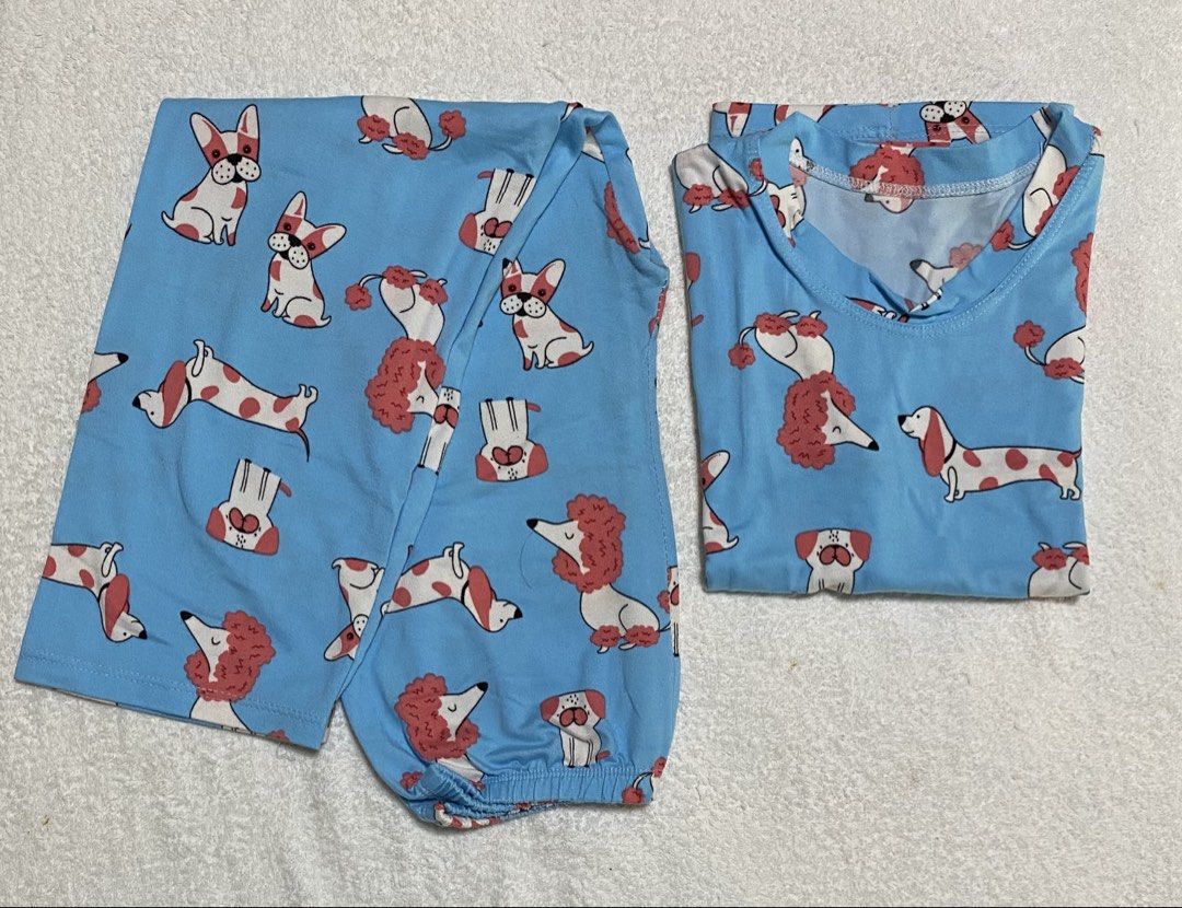 Blue Dog Print Pajama Set (Category: Babies & Kids Fashion) located in Morong. Submitted by ladygjimenez0224 (Listing ID 1466657847, Image 1). Description: - Super soft 100% cotton material for ultimate comfort - Fun, all-over dog illustrations perfect for dog lovers - Short-sleeve top paired with matching bottoms - Comfortable elastic ankles to keep pants in place - Ideal for sleepwear or cozy everyday loungewear.