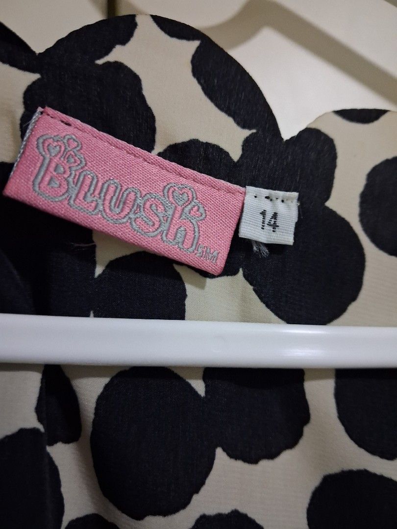 Blush polka dot dress (Category: Dresses) located in Marikina City. Submitted by misskawaii (Listing ID 1466657319, Image 2). Description: - Brand: Blush - Size Kids 14 but worn by a small/petite person - Pattern: Black and cream polka dot - Design: Sleeveless, scalloped neckline, and matching waist tie belt - Fabric: Light and breathable, perfect for warm weather - Style: Versatile piece that can be easily dressed up or down.