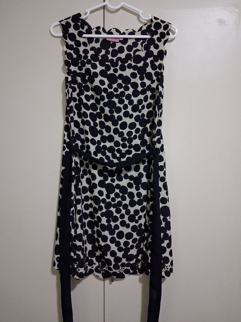 Blush polka dot dress (Category: Dresses) located in Marikina City. Submitted by misskawaii (Listing ID 1466657319, Image 1). Description: - Brand: Blush - Size Kids 14 but worn by a small/petite person - Pattern: Black and cream polka dot - Design: Sleeveless, scalloped neckline, and matching waist tie belt - Fabric: Light and breathable, perfect for warm weather - Style: Versatile piece that can be easily dressed up or down.