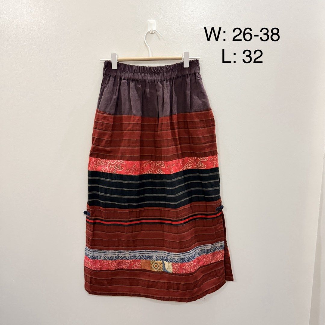 Boho Multicolored Striped Patchwork Maxi Skirt Elastic Waist (Category: Skirts) located in Rodriguez. Submitted by jrms23 (Listing ID 1466769919, Image 1). Description: - Style: Boho vintage-inspired patchwork maxi skirt - Colors: Earthy tones with red, blue, and black horizontal bands - Waist: Elastic waistband, stretches comfortably from 26 to 32 inches - Length: 32 inches total - Details: Unique side tie accents - Condition: Great find, perfec
