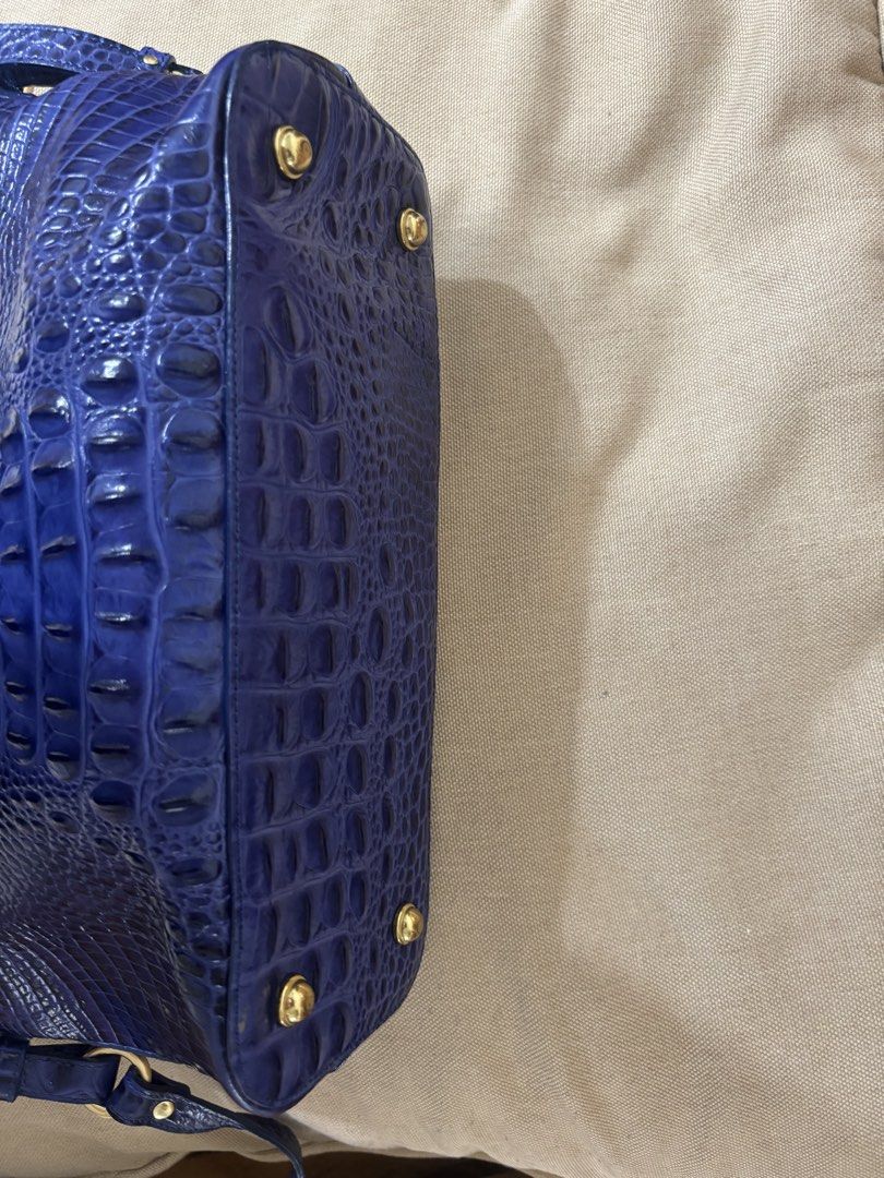 Brahmin Blue Crocodile Embossed Leather Handbag (Category: Shoulder Bags) located in Famy. Submitted by frenchmacaroon (Listing ID 1466580895, Image 3). Description: - Brand: Brahmin - Material: Premium crocodile embossed leather in a stunning blue shade - Hardware: Elegant gold-tone hardware with protective metal feet - Handles: Comfortable double top handles - Accessories: Includes matching tassel charm, guarantee card, and booklet in original 