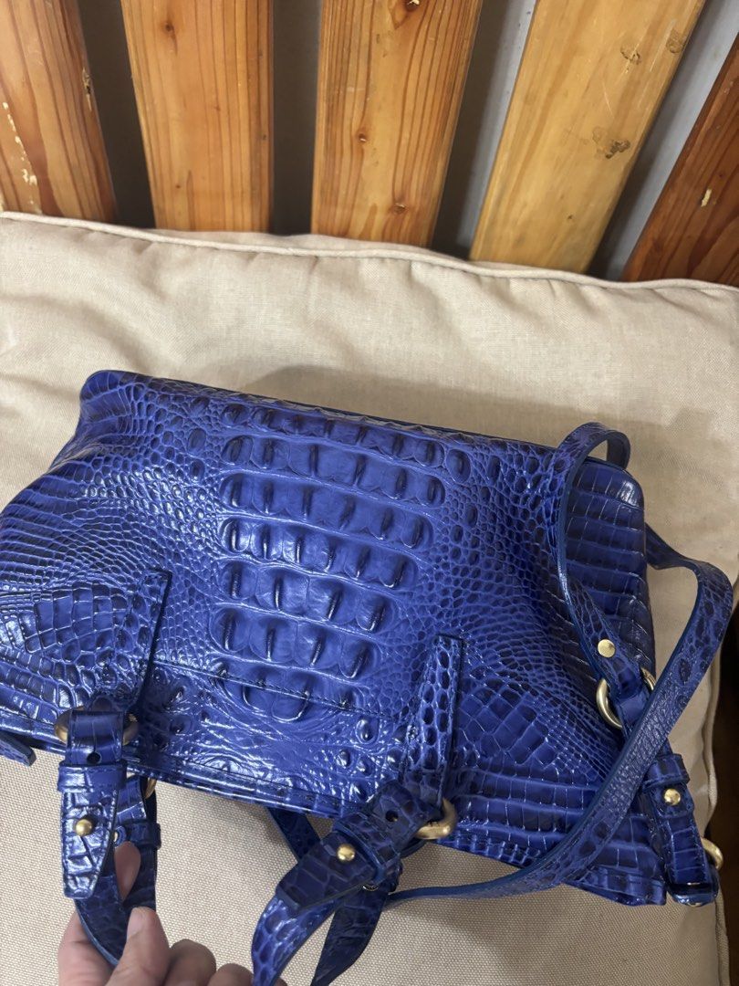Brahmin Blue Crocodile Embossed Leather Handbag (Category: Shoulder Bags) located in Famy. Submitted by frenchmacaroon (Listing ID 1466580895, Image 2). Description: - Brand: Brahmin - Material: Premium crocodile embossed leather in a stunning blue shade - Hardware: Elegant gold-tone hardware with protective metal feet - Handles: Comfortable double top handles - Accessories: Includes matching tassel charm, guarantee card, and booklet in original 