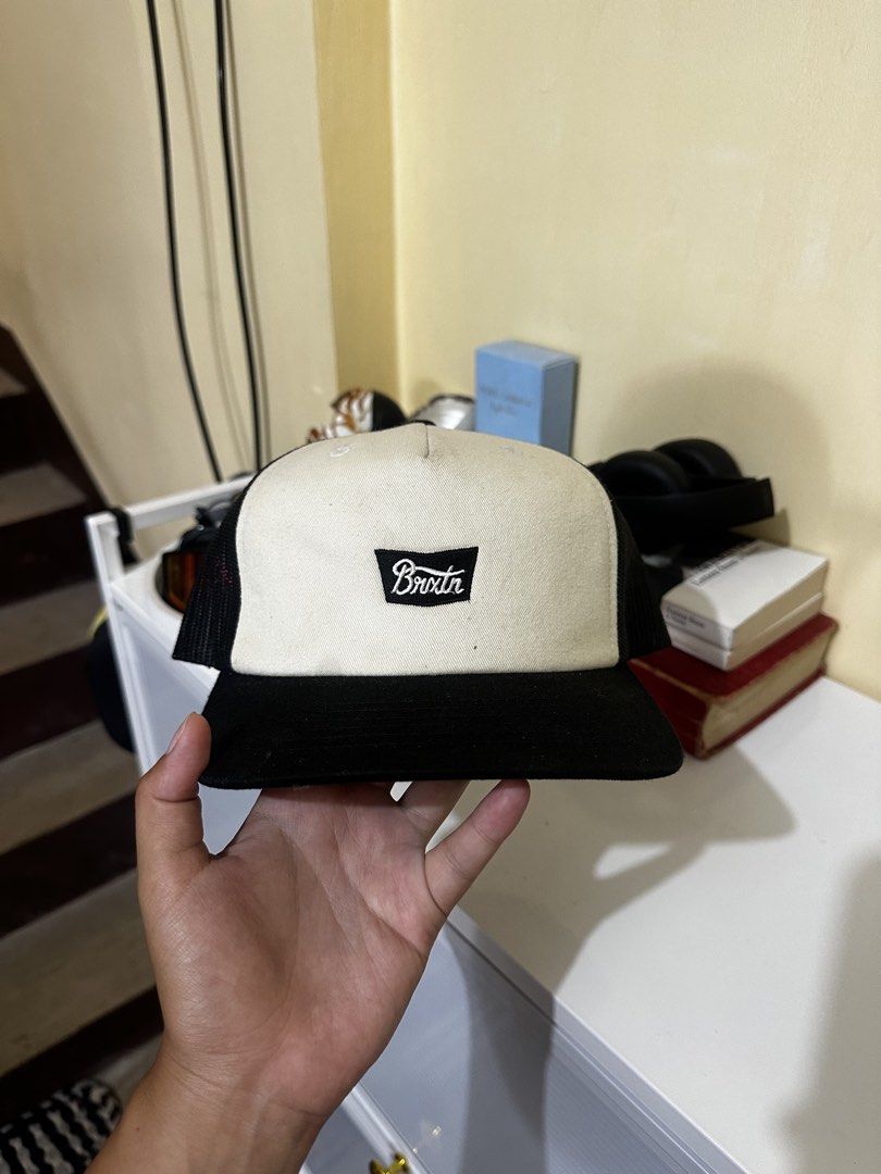 Brixton Trucker Hat (Category: Caps & Hats) located in Baler. Submitted by sidequester (Listing ID 1466582468, Image 1). Description: - Brand: Brixton - Color: Black and Off-White - Design: Structured front panel with centered stitched logo patch - Ventilation: Classic mesh back panels for breathability - Brim: Flat brim style - Fit: Adjustable snapback closure for a custom fit - MOP: Any online bank or e-wallets - MOD: Can do meet up and ship na
