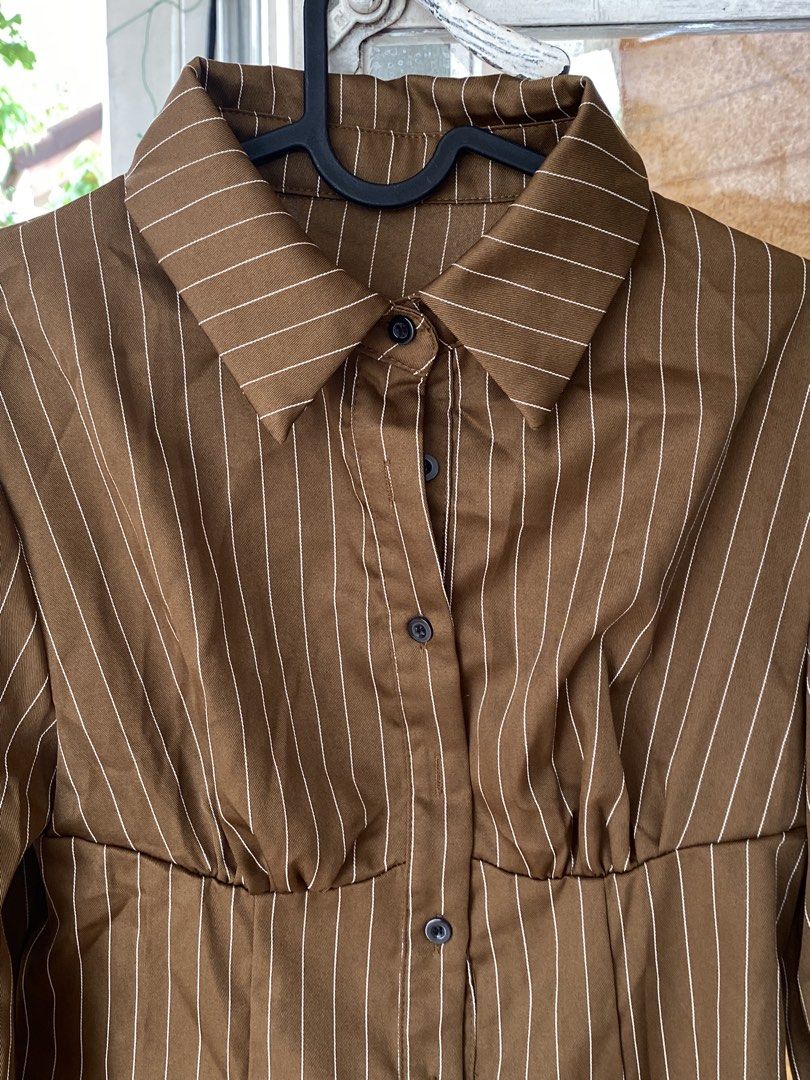 Brown Pinstripe Button-Up Long Sleeve Blouse (Category: Longsleeves) located in Cavite. Submitted by helloize (Listing ID 1466601376, Image 2). Description: Personal favorite 🤎 Smooth texture ng fabric Di gaanong gusutin Lp is 300 Fits XS-S.