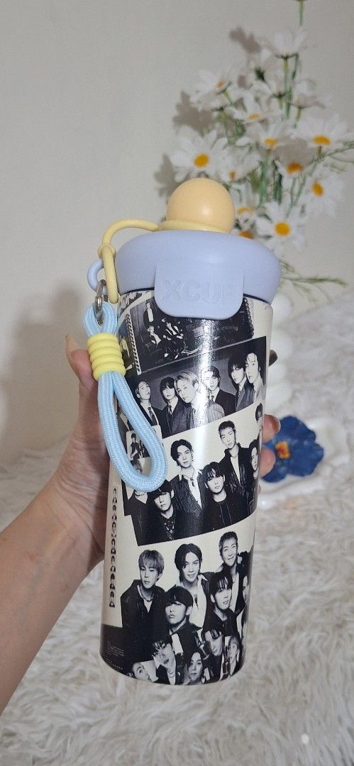 Bts tumbler (Category: K-Wave Merchandise) located in Valenzuela. Submitted by sweetwearph (Listing ID 1466714400, Image 1). Description: no box - Design: Eye-catching black and white K-pop bts member photo collage - Lid & Accents: Light blue lid with stylish yellow accents - Portability: Includes a matching wrist strap for easy carrying on the go - Usage: Perfect fun fan merch and daily hydration tumbler.