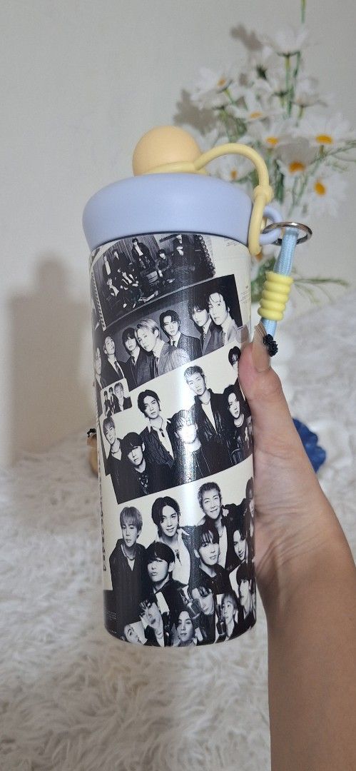 Bts tumbler (Category: K-Wave Merchandise) located in Valenzuela. Submitted by sweetwearph (Listing ID 1466714400, Image 2). Description: no box - Design: Eye-catching black and white K-pop bts member photo collage - Lid & Accents: Light blue lid with stylish yellow accents - Portability: Includes a matching wrist strap for easy carrying on the go - Usage: Perfect fun fan merch and daily hydration tumbler.