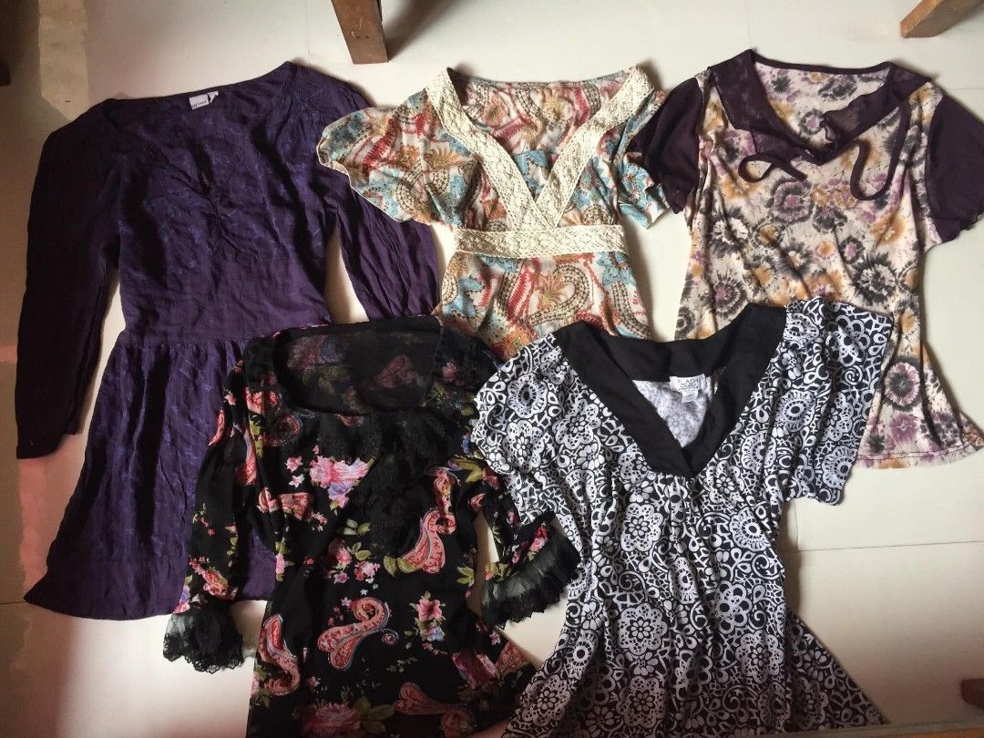 Bundle of 5 Assorted Patterned Women Tops Blouses (Category: Blouses) located in Aloran. Submitted by thriftfinds.co (Listing ID 1466716020, Image 1). Description: - Set of 5 stylish women's tops - Includes solid purple tunic, cream floral/paisley with lace, abstract purple print, black floral/paisley with lace cuffs, and B&W patterned top - Mixed necklines and sleeve lengths - Perfect for effortless everyday styling - Great value bundle!.