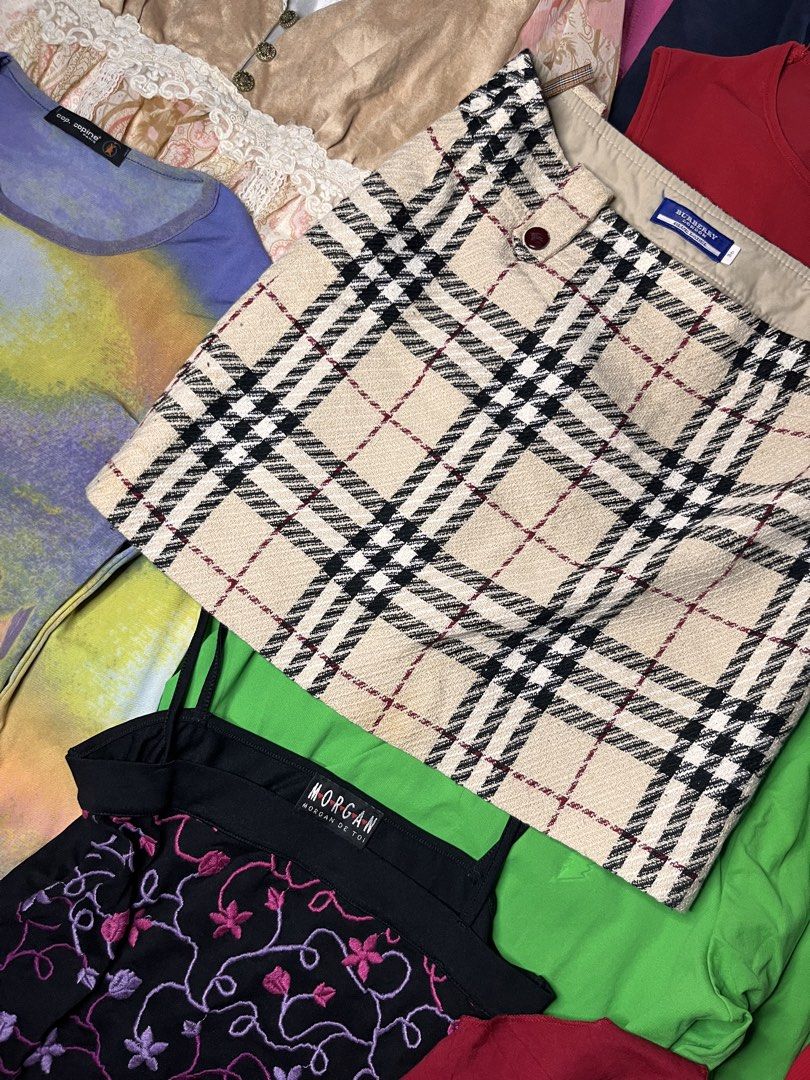 Burberry Blue Label Plaid Mini Skirt (Category: Skirts) located in Catbalogan. Submitted by yellfindss (Listing ID 1466755516, Image 3). Description: Burberry Blue Label mini skirt in classic beige check pattern. Black and red lines throughout. Structured wool-blend fabric with smooth lining inside. Side zipper closure. Branded red buttons on the waist tabs. Interior features signature Nova check hanging loops. Size 36 tag on the inner label. Y2K
