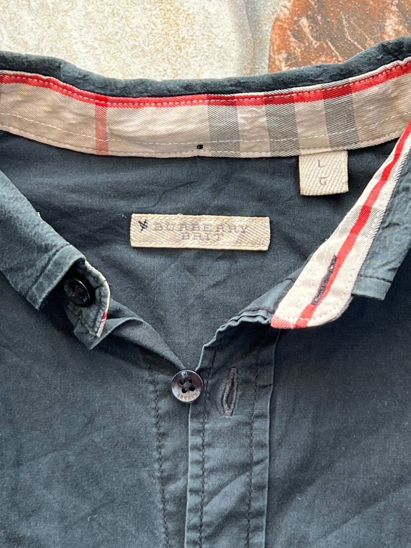 Burberry Brit Black Button Down Shirt Size L (Category: Shirts) located in Caloocan City. Submitted by sillapwet0606 (Listing ID 1466566632, Image 3). Description: - Brand: Burberry Brit - Color: Black - Size: L (tag on collar) - Logo: Classic embroidered equestrian knight on chest - Detail: Iconic check pattern lining inside the collar - Closure: Branded buttons down the front - Care: Machine washable - Material Note: Contains non-textile parts 