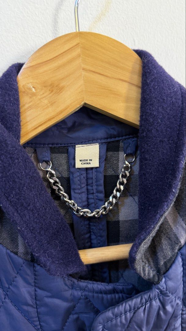 Burberry Quilted Jacket Navy Blue (Category: Coats, Jackets and Outerwear) located in Paranaque City. Submitted by preluxeshop_ph (Listing ID 1466761309, Image 3). Description: Burberry Quilted Jacket Navy Blue - Navy blue color - Iconic checked lining - Stylish chain detail at the collar - Material: 100% Polyester (outer), Cotton (lining) - Perfect for layering - Size: UK 10 / ITA 42.