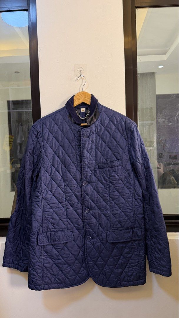Burberry Quilted Jacket Navy Blue (Category: Coats, Jackets and Outerwear) located in Paranaque City. Submitted by preluxeshop_ph (Listing ID 1466761309, Image 2). Description: Burberry Quilted Jacket Navy Blue - Navy blue color - Iconic checked lining - Stylish chain detail at the collar - Material: 100% Polyester (outer), Cotton (lining) - Perfect for layering - Size: UK 10 / ITA 42.