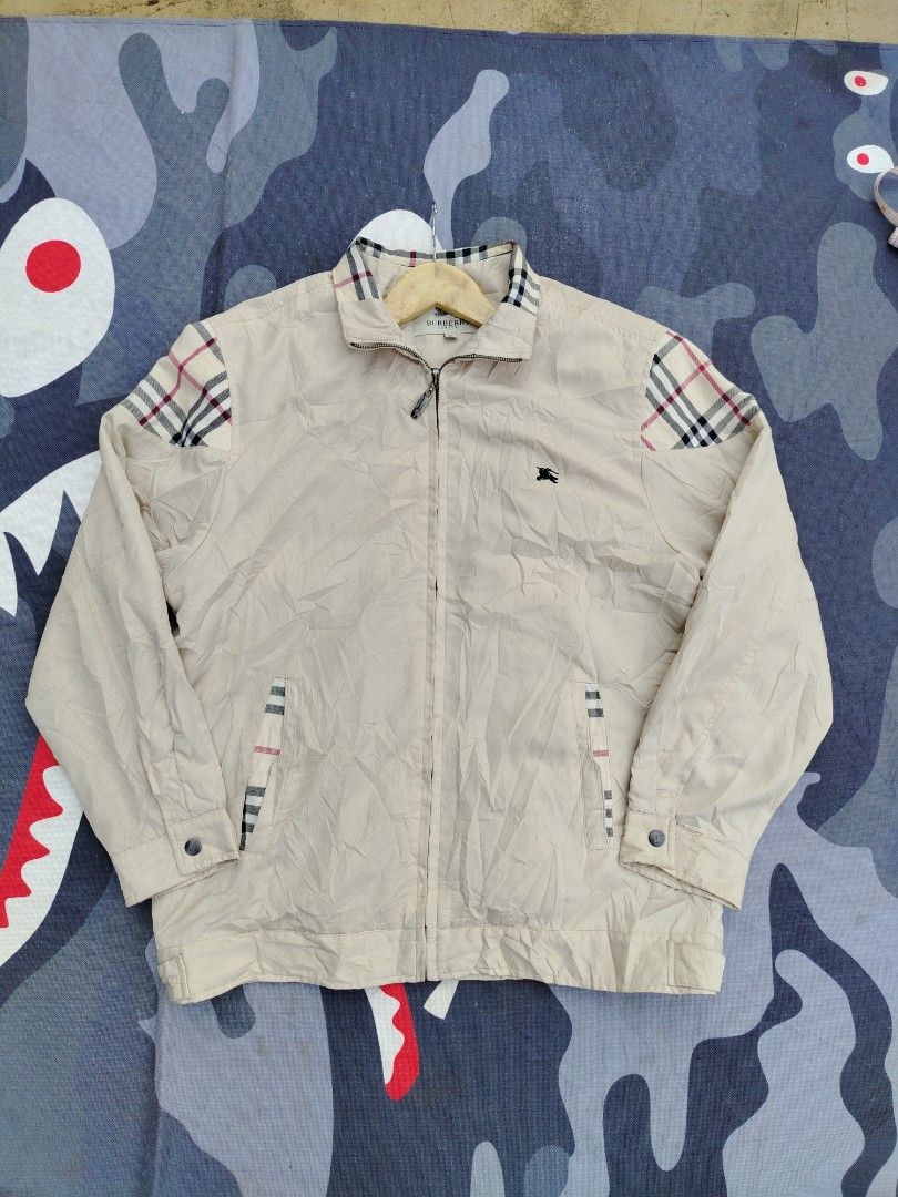 BURBERRY VINTAGE BEIGE ZIP UP JACKET (Category: Coats, Jackets and Outerwear) located in Don Carlos. Submitted by thriftnidodong_23 (Listing ID 1466576903, Image 1). Description: This appears to be a vintage beige Burberry zip-up jacket, featuring the signature Nova Check pattern on the shoulder panels. 22.5X28.