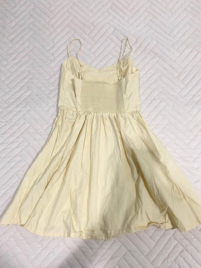 Butter yellow Dress (Category: Dresses) located in Manila. Submitted by pandaaa_loo (Listing ID 1466725637, Image 2). Description: - Color: butter yellow - Style: Sleeveless skater dress with spaghetti straps and sweetheart neckline - Fit: Fitted bodice, flared pleated skirt, and smocked back panel for stretch - Fabric: Light and breezy, perfect for warm weather - Condition: Needs a quick steam iron due to storage folds.