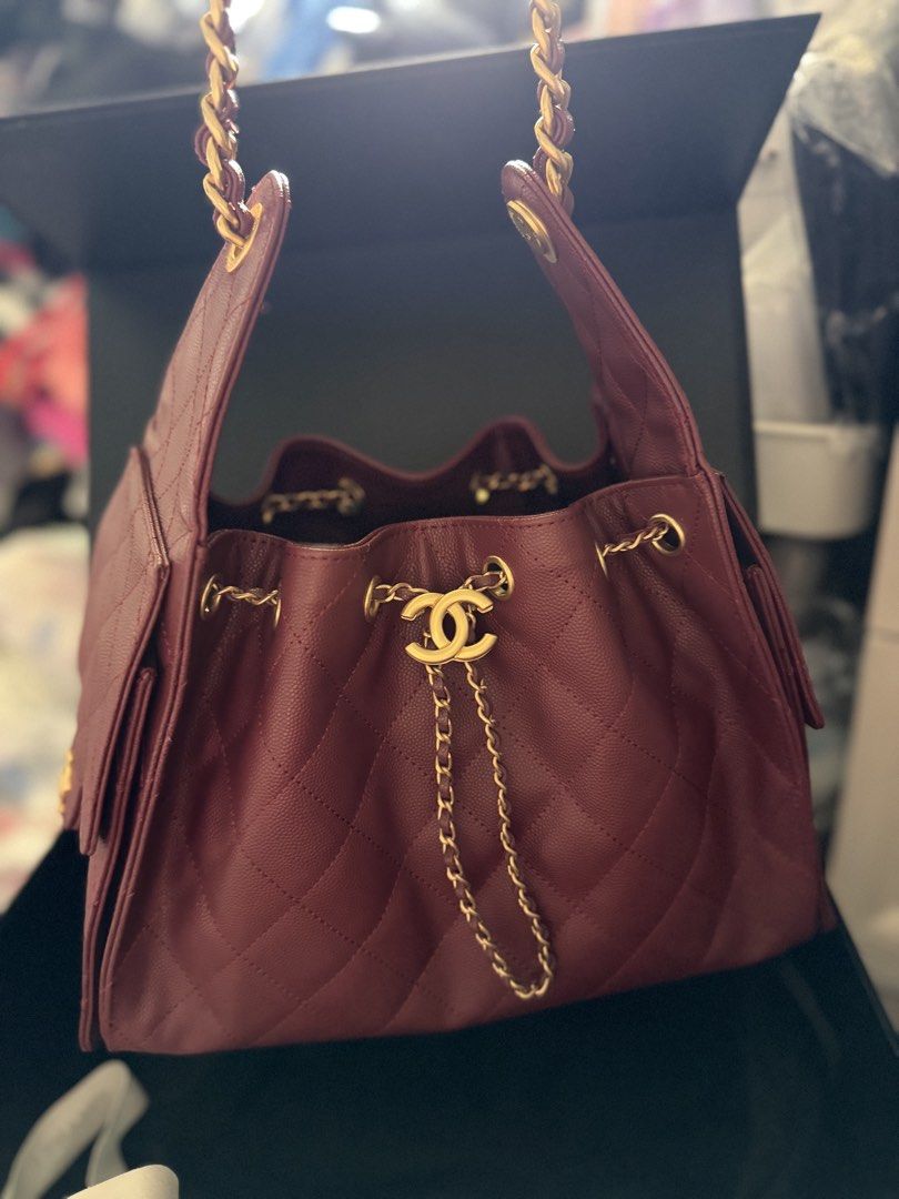 C25 Burgundy Caviar Leather Bag (Category: Purses & Pouches) located in Pasig City. Submitted by glamomma (Listing ID 1466580670, Image 3). Description: RUSH SALE!!! Burgundy caviar leather chain bag, gold hardware. Drawstring closure with interlocking CC logo charm. Diamond quilting pattern throughout. Side flap pockets with CC turn-locks. Chain strap interwoven with matching leather..