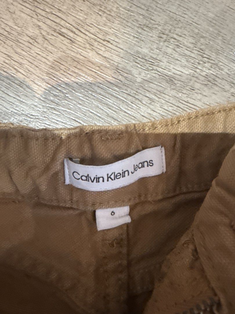 Calvin Klein Jeans Brown Cargo Pants Size 6 (Category: Babies & Kids Fashion) located in Quezon City. Submitted by zencat.693786 (Listing ID 1466591182, Image 2). Description: - Brand: Calvin Klein Jeans - Size: 6 (tag inside waistband) - Color: Versatile brown - Style: Classic cargo pockets with snap buttons - Comfort: Elastic waistband design at the back for easy movement - Material: Durable fabric, perfect for everyday kids' wear - Condition: 