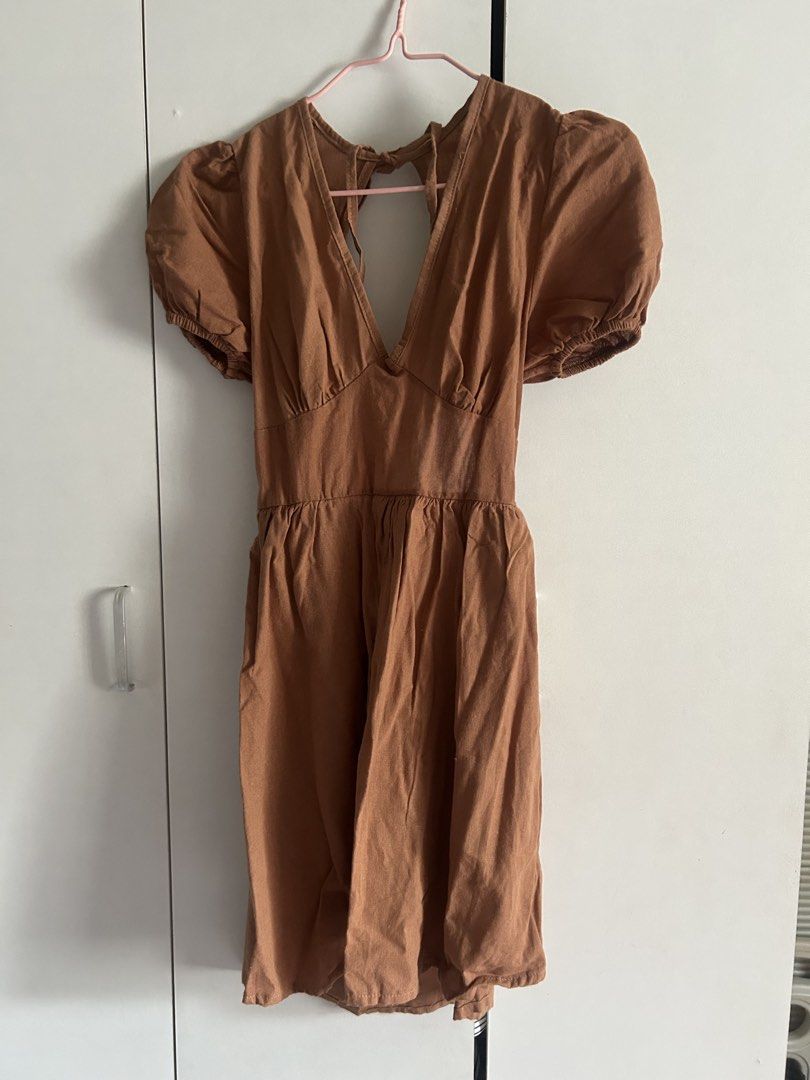 Candy Brown Puff Sleeve Open Back Dress (Category: Dresses) located in Quezon City. Submitted by emayeah (Listing ID 1466574769, Image 1). Description: - Style: Brown puff sleeve dress with a deep V-neck and open back - Fit: Fitted waist with a flared mini skirt - Details: Tied closure at the back neck - Condition: Brand new with original store tags still attached, never worn - Size: Medium.