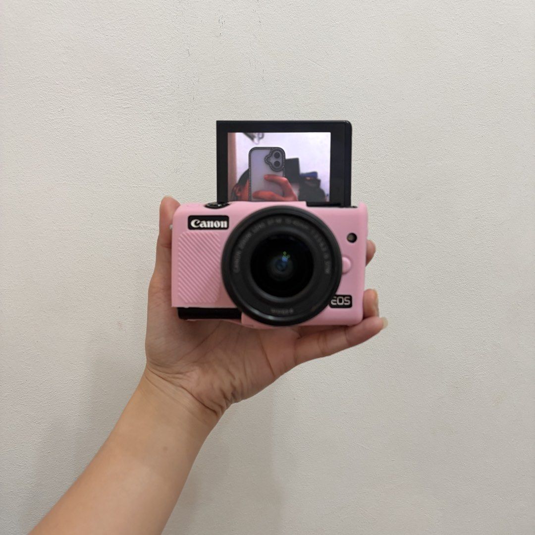 Canon EOS M100 Mirrorless Camera with Pink Case and Accessories (Category: Cameras) located in Valenzuela. Submitted by crisalyz (Listing ID 1466756326, Image 3). Description: IN COLOR BLACK 🖤 (mirrorless camera) ✔️best alternative for Canon G7X Mark Series and Canon SX740HS ㅤᵕ̈ 𖤓 PM ME FOR MORE SAMPLE PICS NO FUNCTIONAL ISSUE! about: - 24.2 MP | full hd video - touchscreen - flipscreen - pop-up flash - red eye flash - wifi transfer (very conve
