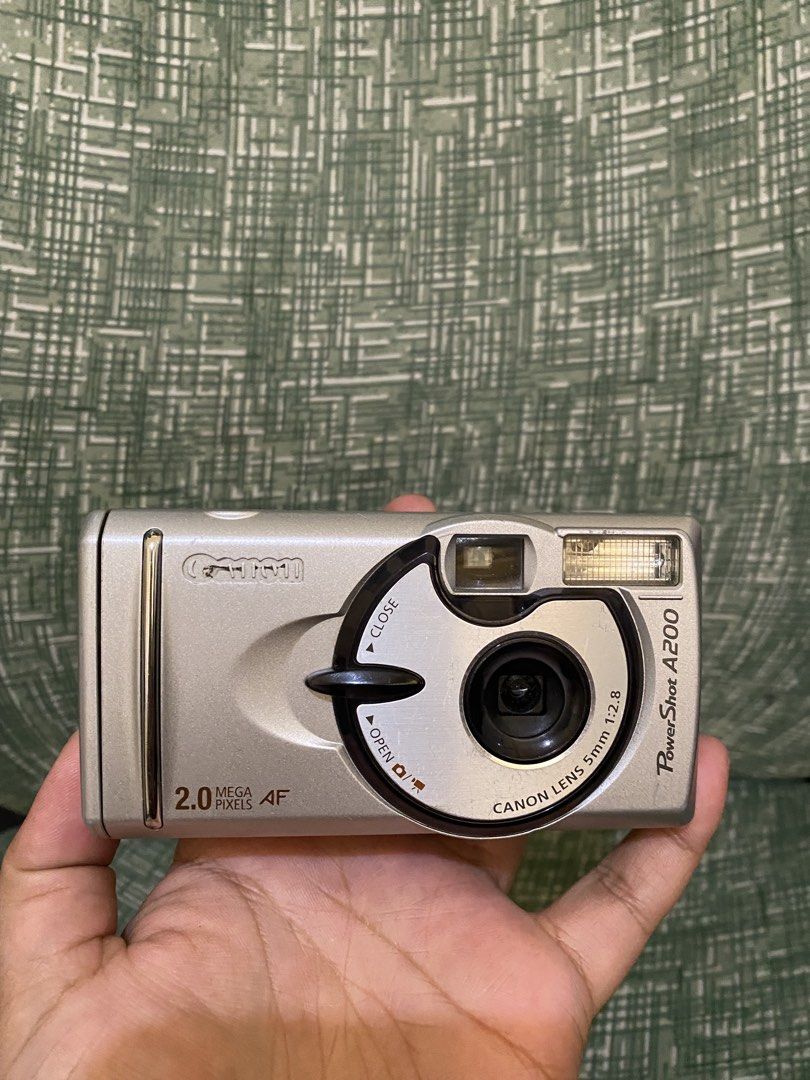 Canon PowerShot A200 2.0 Mega Pixels Digital Camera (Category: Cameras) located in Baguio. Submitted by thrift_bonita (Listing ID 1466607854, Image 2). Description: - Model: Vintage Canon PowerShot A200 compact digital camera - Resolution & Zoom: 2.0 megapixels with 4x digital zoom - Power & Storage: Runs on standard AA batteries and uses CompactFlash memory cards - Condition: Clean battery compartment and CF card slot with a working latch - Desi