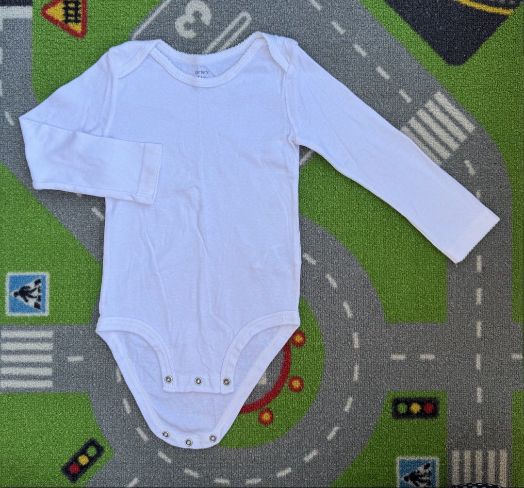 Carter's Long Sleeve Onesie Bodysuit (Category: Babies & Kids Fashion) located in Rizal. Submitted by preloovved (Listing ID 1466674591, Image 1). Description: Preloved, 24mos, Plain white Carter's long sleeve baby bodysuit in soft cotton. Features bottom snaps and a cute scalloped neckline. A versatile wardrobe basic, easy to pair with any bottoms. Carter’s white long-sleeved bodysuit. Round neck, snap closures. Soft, comfortable fabric. Perfect