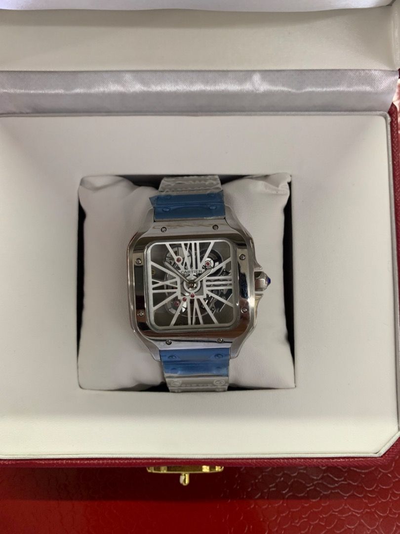 Cartier Skeleton Watch (Category: Luxury Watches) located in Caloocan City. Submitted by mrbigdreams (Listing ID 1466571888, Image 1). Description: - Condition: Brand new and unworn with factory protective plastic still on the bracelet and clasp - Design: Silver-tone square case with a stunning exposed mechanical movement dial - Details: Classic white Roman numeral indexes and a signature blue cabochon crown - Packaging: Comes complete with the i