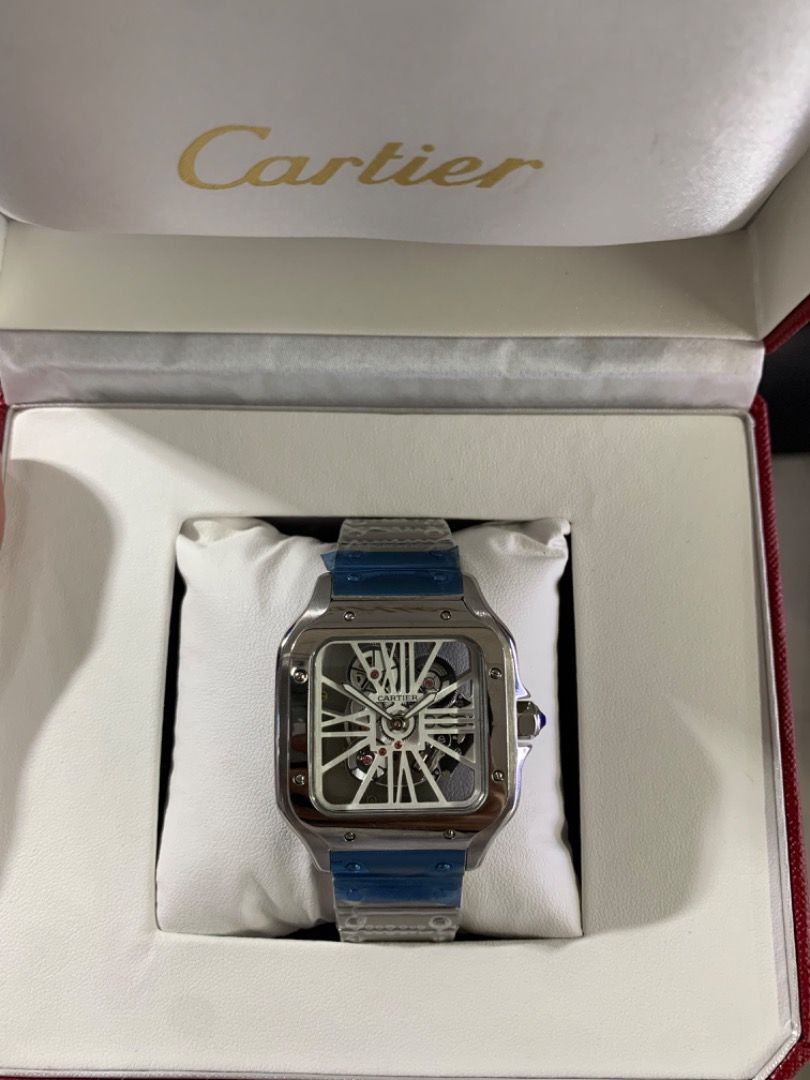 Cartier Skeleton Watch (Category: Luxury Watches) located in Caloocan City. Submitted by mrbigdreams (Listing ID 1466571888, Image 2). Description: - Condition: Brand new and unworn with factory protective plastic still on the bracelet and clasp - Design: Silver-tone square case with a stunning exposed mechanical movement dial - Details: Classic white Roman numeral indexes and a signature blue cabochon crown - Packaging: Comes complete with the i