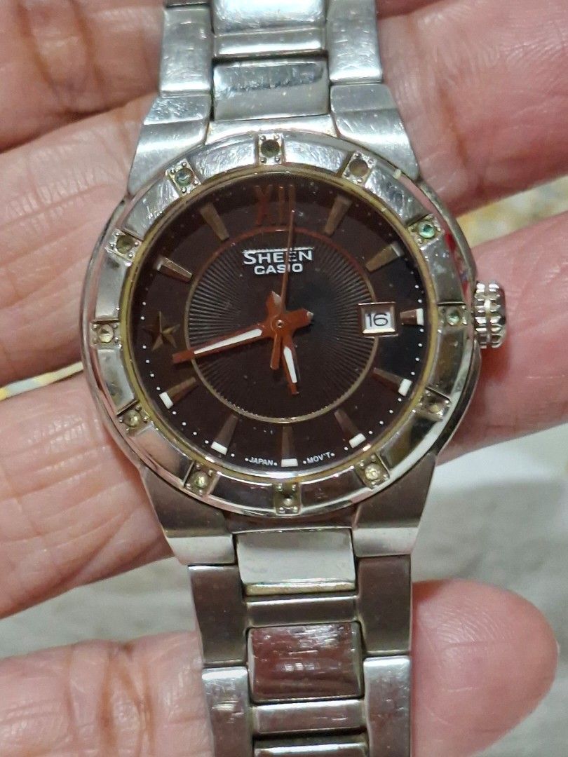 Casio Sheen Analog Watch with Date Display (Category: Women's Watches) located in Bulacan. Submitted by rafaesarisari (Listing ID 1466672532, Image 1). Description: - Brand/Model: Casio Sheen Women's Watch - Dial: Dark brown textured dial with clear date window at 3 o'clock - Bezel: Elegant crystal markers set around the bezel - Movement: Reliable Japan movement - Band: Silver-tone stainless steel bracelet with standard crown - Condition: Normal 