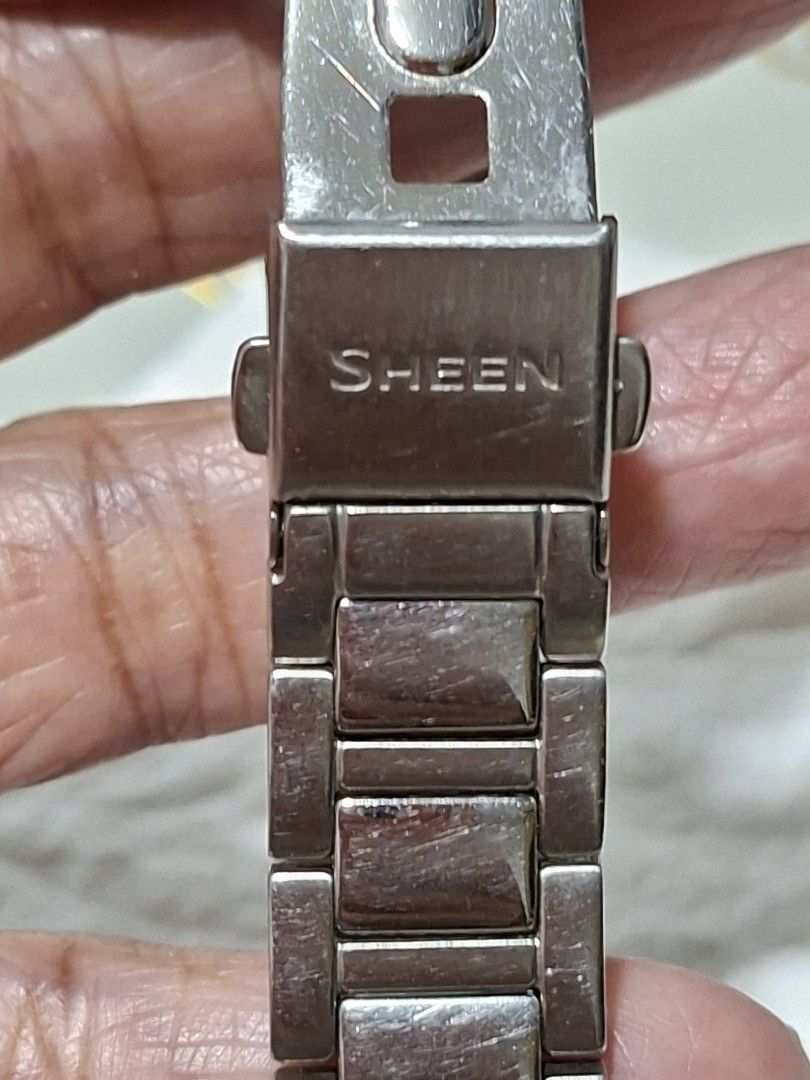 Casio Sheen Analog Watch with Date Display (Category: Women's Watches) located in Bulacan. Submitted by rafaesarisari (Listing ID 1466672532, Image 3). Description: - Brand/Model: Casio Sheen Women's Watch - Dial: Dark brown textured dial with clear date window at 3 o'clock - Bezel: Elegant crystal markers set around the bezel - Movement: Reliable Japan movement - Band: Silver-tone stainless steel bracelet with standard crown - Condition: Normal 