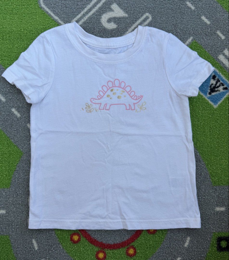 Cat & Jack T-Shirt with Dinosaur Graphic (Category: Babies & Kids Fashion) located in Rizal. Submitted by preloovved (Listing ID 1466677911, Image 1). Description: Preloved, 2yo, Super cute white kids' t-shirt featuring a pink dinosaur graphic with metallic gold details. Made from soft cotton for all-day comfort. Perfect for casual wear and easy to match with jeans or shorts! C-2.