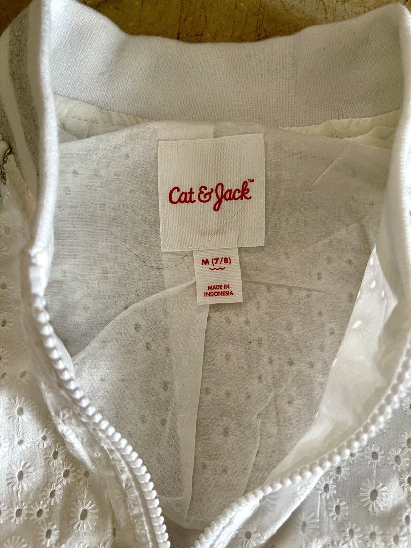 Cat & Jack White Eyelet Bomber Jacket (Category: Babies & Kids Fashion) located in San Juan City. Submitted by rike_ramirez (Listing ID 1466600562, Image 2). Description: Original and authentic, purchased in the USA Brand: Cat & Jack - Size: M (Ages 7/8) - Color: Fresh white with silver accents - Design: All-over eyelet embroidery with silver metallic ribbed collar, cuffs, and hem - Details: Chic silver piping along raglan sleeves and full front 