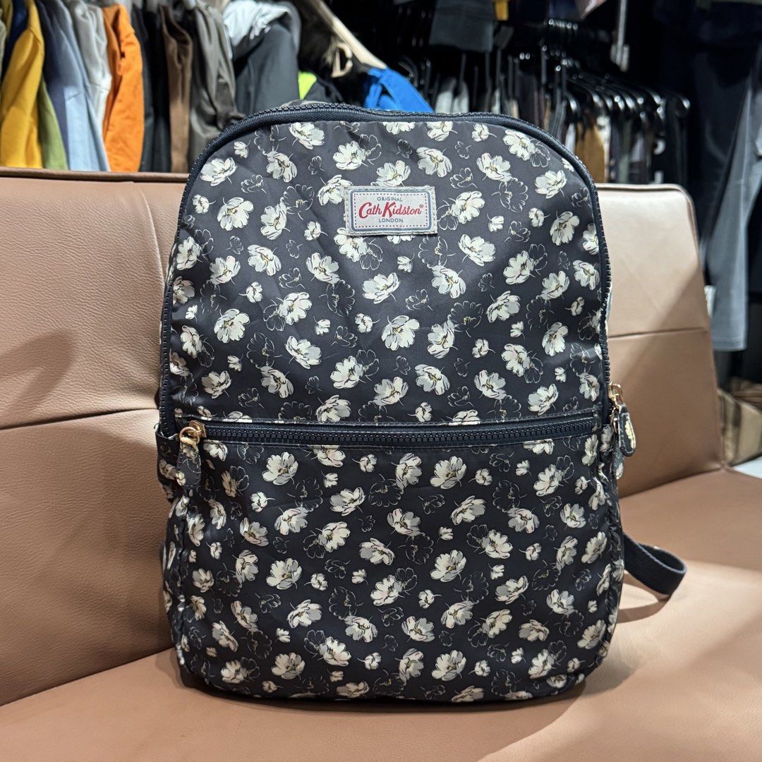 Cath Kidston Black Floral Backpack (Category: Backpacks) located in Rizal. Submitted by houseofbell (Listing ID 1466729059, Image 1). Description: - Authentic Cath Kidston backpack in classic black with an all-over white floral pattern - Front zippered pocket for quick access to essentials - Spacious main compartment with a separate interior button pocket - Dual adjustable shoulder straps for a comfortable fit - Clean interior lining with officia