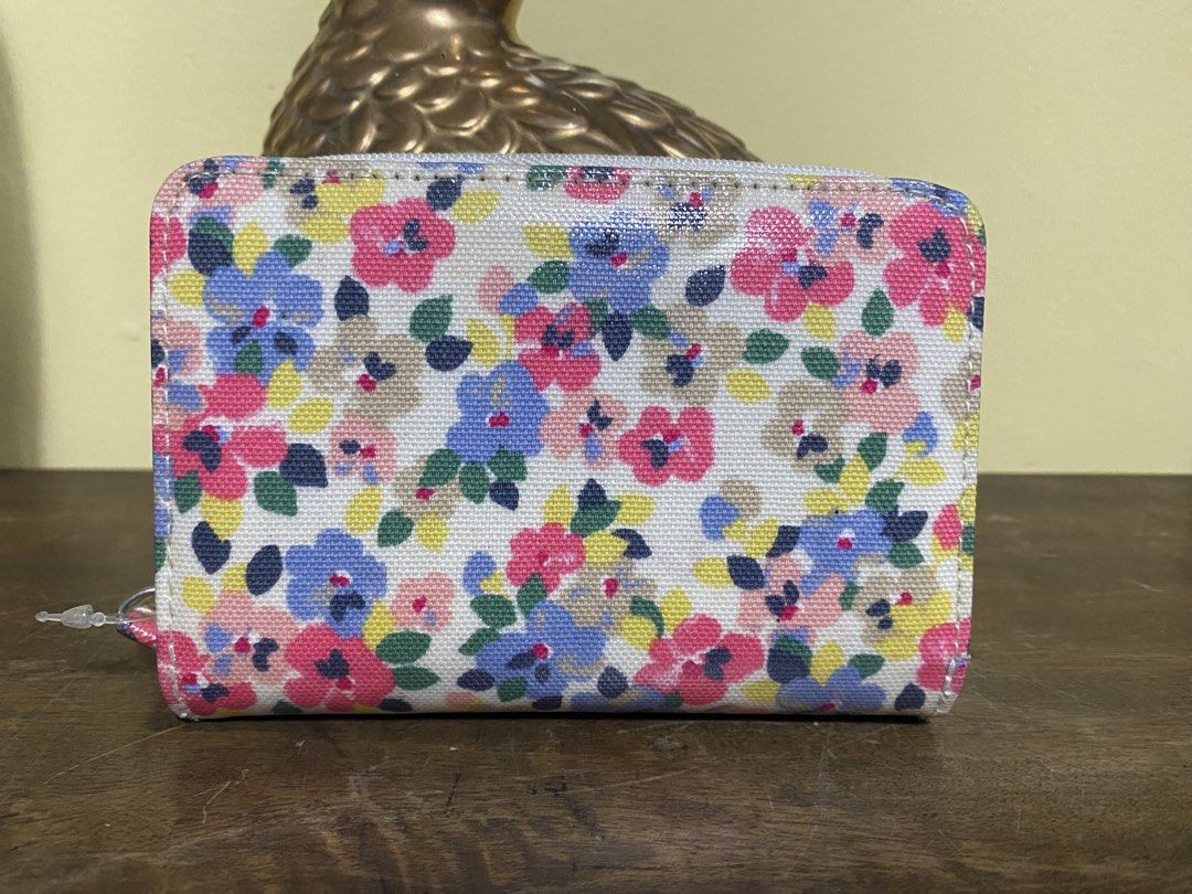 Cath Kidston Floral Zip Around Wallet (Category: Wallets & Card holders) located in Baguio. Submitted by SweetRepeat (Listing ID 1466572114, Image 2). Description: - Brand new with original store tags attached - Authentic Cath Kidston design featuring a white background with vibrant floral print - Secure snap button main closure and all-around white zip closure - Multiple card slots to keep your cards organized - Convenient zippered coin compartm