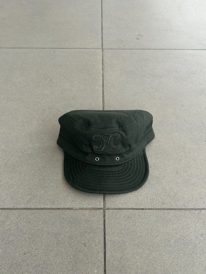 Celine Dark Green Cadet Cap (Category: Caps & Hats) located in Pasig City. Submitted by paulclzdo (Listing ID 1466639147, Image 1). Description: - Brand: Celine - Style: Cadet Cap - Color: Dark Green - Size: Medium (M) - Details: Embroidered Triomphe logo on the front - Closure: Adjustable metal strap at the back - Condition: Clean interior lining with original brand labels attached.