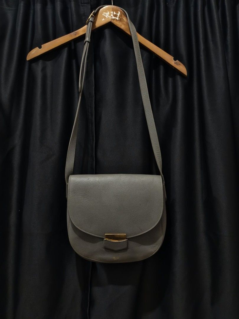 Celine Grey Leather Crossbody Bag (Category: Luxury Bags & Wallets) located in Baguio. Submitted by solo_ukay (Listing ID 1463808514, Image 1). Description: - Authentic Celine grey leather crossbody bag - Features a front zip pocket - Secure flap closure with a gold buckle - Adjustable strap for comfortable wear - Classic, minimalist design perfect for everyday use - Shows minor signs of wear on the hardware.