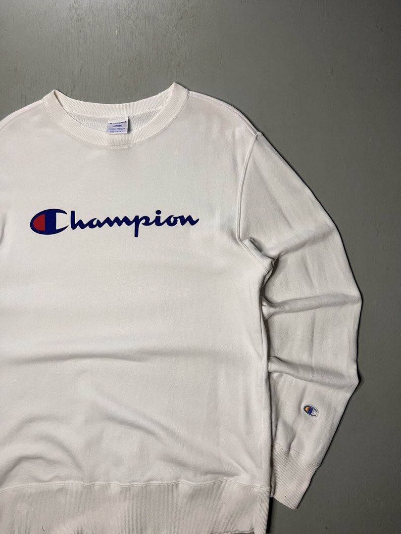 Champion White Script Logo Sweatshirt Size Large (Category: Coats, Jackets and Outerwear) located in Catbalogan. Submitted by yellfindss (Listing ID 1466741719, Image 2). Description: - Brand: Champion 20/27 - Style: Classic crewneck sweatshirt with script logo - Size: Large - Color: White - Condition: Clean fabric with comfy fleece interior - Details: Ribbed cuffs and hem, iconic embroidered sleeve patch - Perfect for: Cool weather layering.
