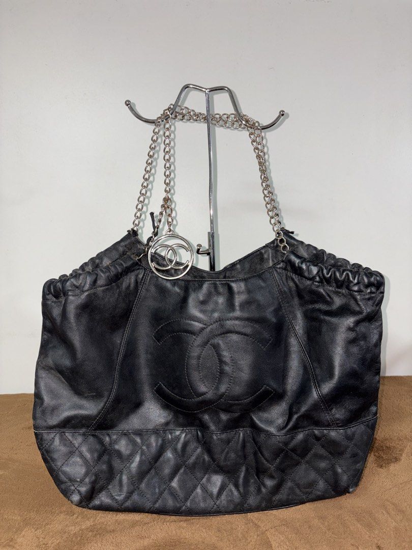 Chanel Black Leather Chain Shoulder Bag (Category: Luxury Bags & Wallets) located in Baguio. Submitted by maje_mori (Listing ID 1466704458, Image 1). Description: - Style: Chanel Shoulder bag / Drawstring bucket bag. - Condition: General wear on leather trim and edges; slight tarnish on chains (check photos for references)..