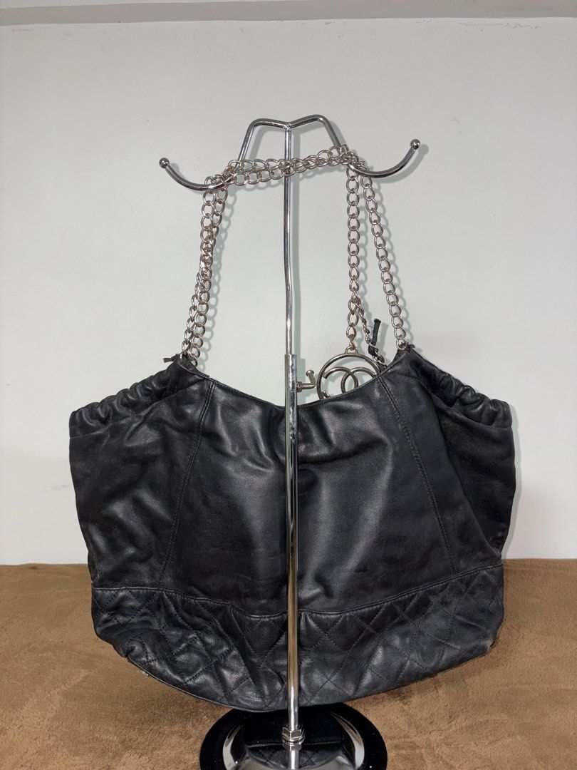 Chanel Black Leather Chain Shoulder Bag (Category: Luxury Bags & Wallets) located in Baguio. Submitted by maje_mori (Listing ID 1466704458, Image 2). Description: - Style: Chanel Shoulder bag / Drawstring bucket bag. - Condition: General wear on leather trim and edges; slight tarnish on chains (check photos for references)..