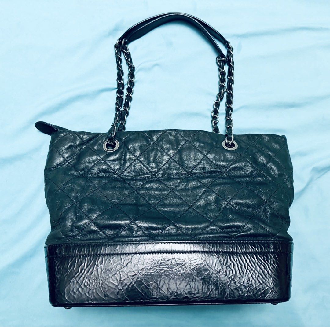 Chanel Gabrielle Two-Tone Tote Bag (Category: Luxury Bags & Wallets) located in Marikina City. Submitted by mommymishy (Listing ID 1466564468, Image 3). Description: - Brand: Chanel - Style: Tote bag in classic black - Material: Quilted leather with a structured patent leather base - Secure zip top closure - Interior: Deep, spacious compartment with Chanel logo lining Chanel Gabrielle Tote, Iridescent Black and Blue No inclusions but hologram int