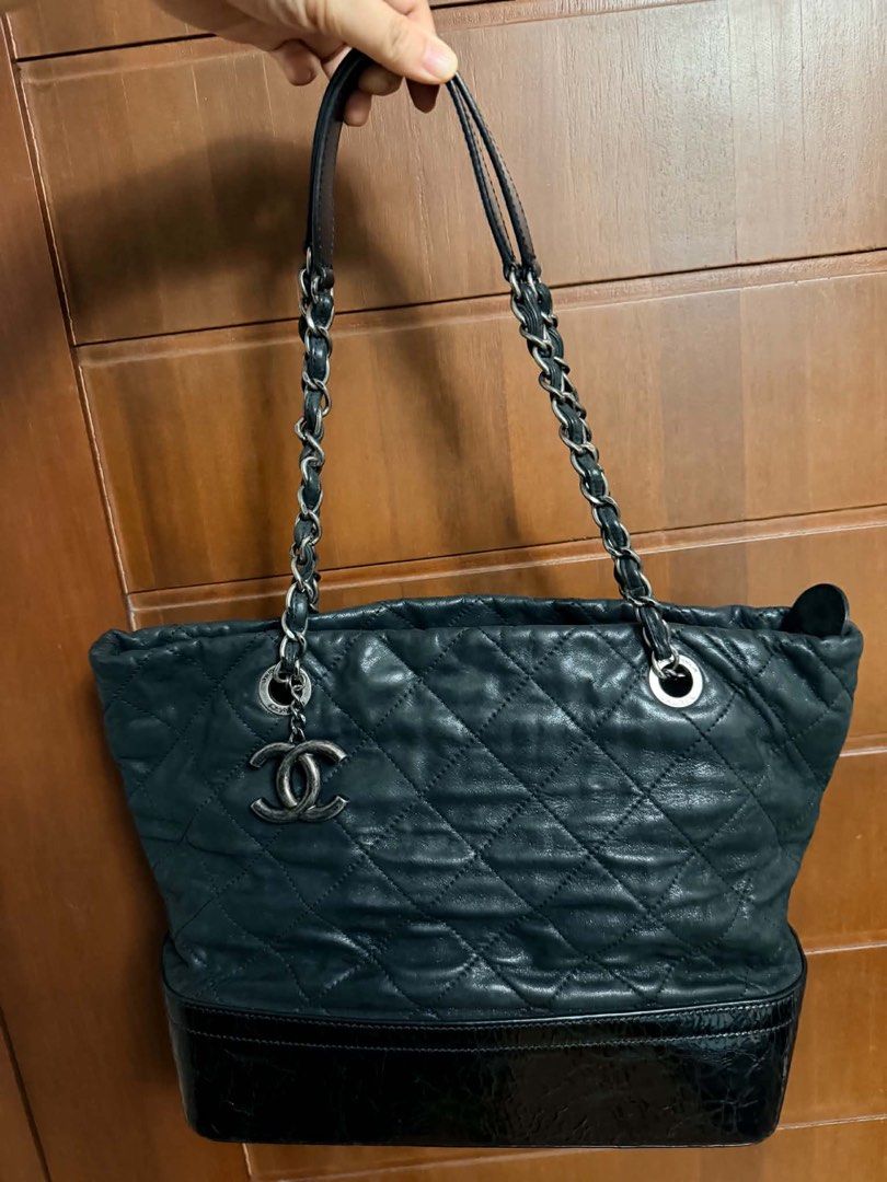 Chanel Gabrielle Two-Tone Tote Bag (Category: Luxury Bags & Wallets) located in Marikina City. Submitted by mommymishy (Listing ID 1466564468, Image 2). Description: - Brand: Chanel - Style: Tote bag in classic black - Material: Quilted leather with a structured patent leather base - Secure zip top closure - Interior: Deep, spacious compartment with Chanel logo lining Chanel Gabrielle Tote, Iridescent Black and Blue No inclusions but hologram int