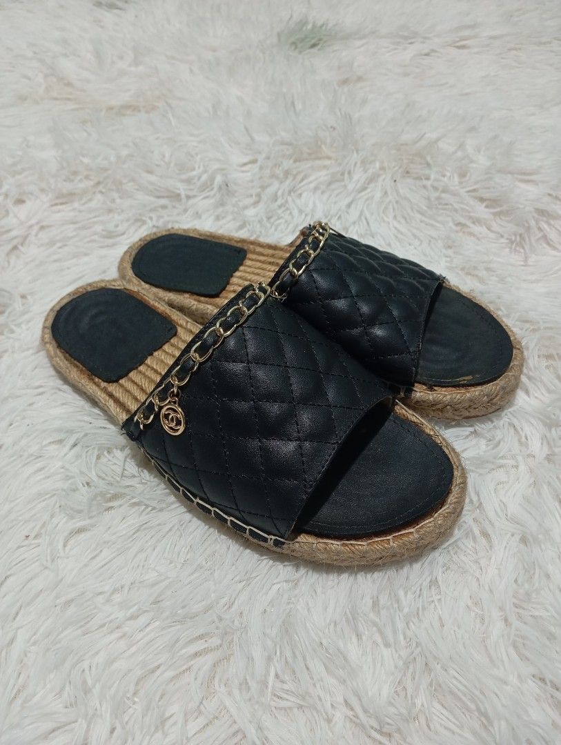Chanel Quilted CC Chain Espadrille Mule / Slide (Category: Sneakers & Footwear) located in Quezon City. Submitted by thesecondmarketph (Listing ID 1466757330, Image 1). Description: - Style: Slip-on slide sandals - Color/Design: Black quilted upper with espadrille jute rope trim - Details: Woven gold chain accent featuring a hanging round interlocking CC logo charm - Soles: Flat with black inner footbeds - Condition: Worn a few times, with minor 