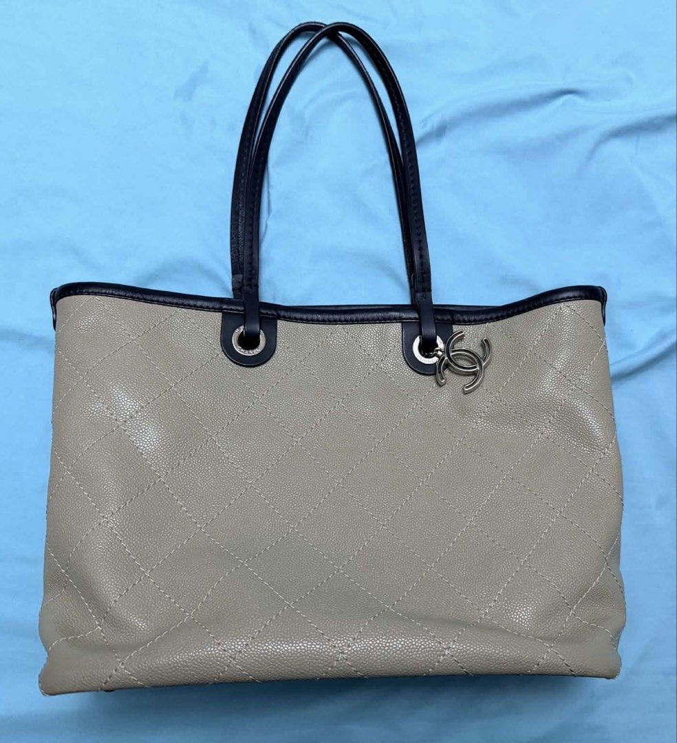 Chanel Tote Bag with Pouch (Category: Tote Bags) located in Marikina City. Submitted by mommymishy (Listing ID 1466564617, Image 2). Description: - Authentic Chanel beige quilted leather tote bag - Features dark trim handles and silver-tone hardware - Includes matching detachable pouch with strap and classic CC charm - Generous size with a structured shape, ideal for daily use Chanel tote bag caviar Comes with card and pouch Hologram intact Serie