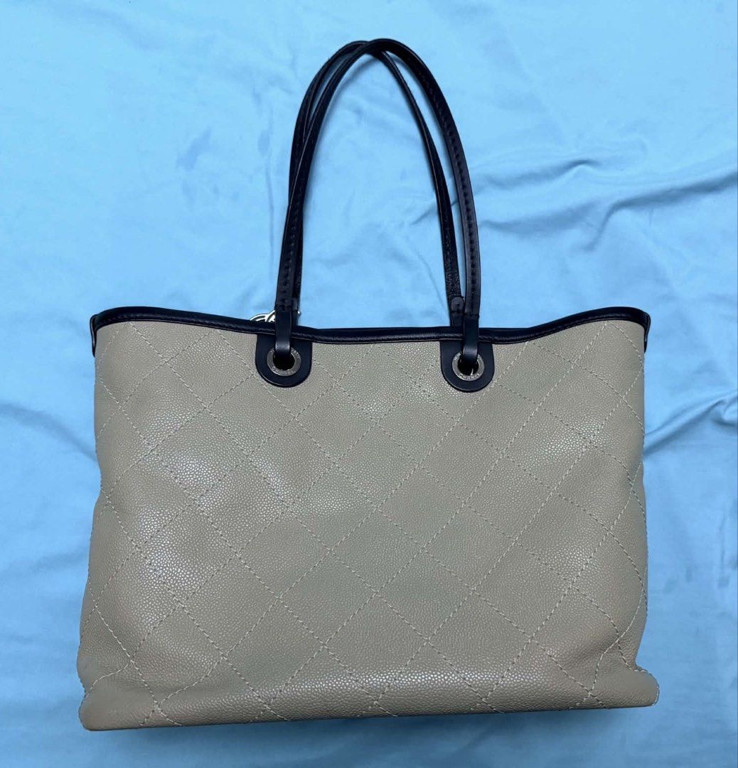 Chanel Tote Bag with Pouch (Category: Tote Bags) located in Marikina City. Submitted by mommymishy (Listing ID 1466564617, Image 3). Description: - Authentic Chanel beige quilted leather tote bag - Features dark trim handles and silver-tone hardware - Includes matching detachable pouch with strap and classic CC charm - Generous size with a structured shape, ideal for daily use Chanel tote bag caviar Comes with card and pouch Hologram intact Serie