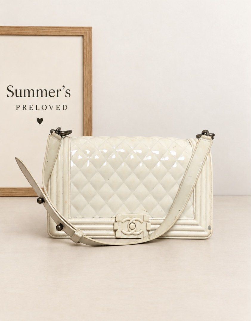 Chanene Old Medium Boy Bag (Category: Cross-body Bags) located in Taguig. Submitted by summers.preloved (Listing ID 1466679236, Image 1). Description: 👜 👜 BAG DETAILS 🤍 Color: Ivory / cream, with visible discoloration in several areas. ✨ Finish: Glossy, patent-look exterior with diamond quilting. Exact leather type is unconfirmed. 🪡 Design: Structured rectangular body framed by raised, layered borders. 🔐 Closure: Front flap with an ivory-ton