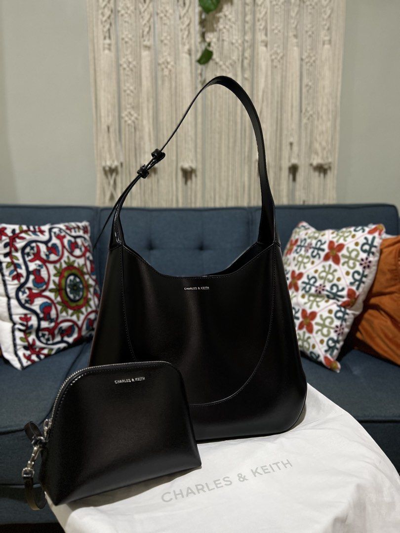 Charles & Keith Black HOBO Bag With Pouch (Category: Shoulder Bags) located in Davao. Submitted by bengscloset (Listing ID 1466649551, Image 1). Description: Brand: Charles & Keith Color: Black Material: Smooth faux leather with silver-tone hardware Details: Structured shoulder bag with magnetic closure & adjustable strap Inclusion: Matching zipped pouch and original dust bag Condition: Excellent, like new 📌 No rush shipping. 📦 Shipping fee c/o