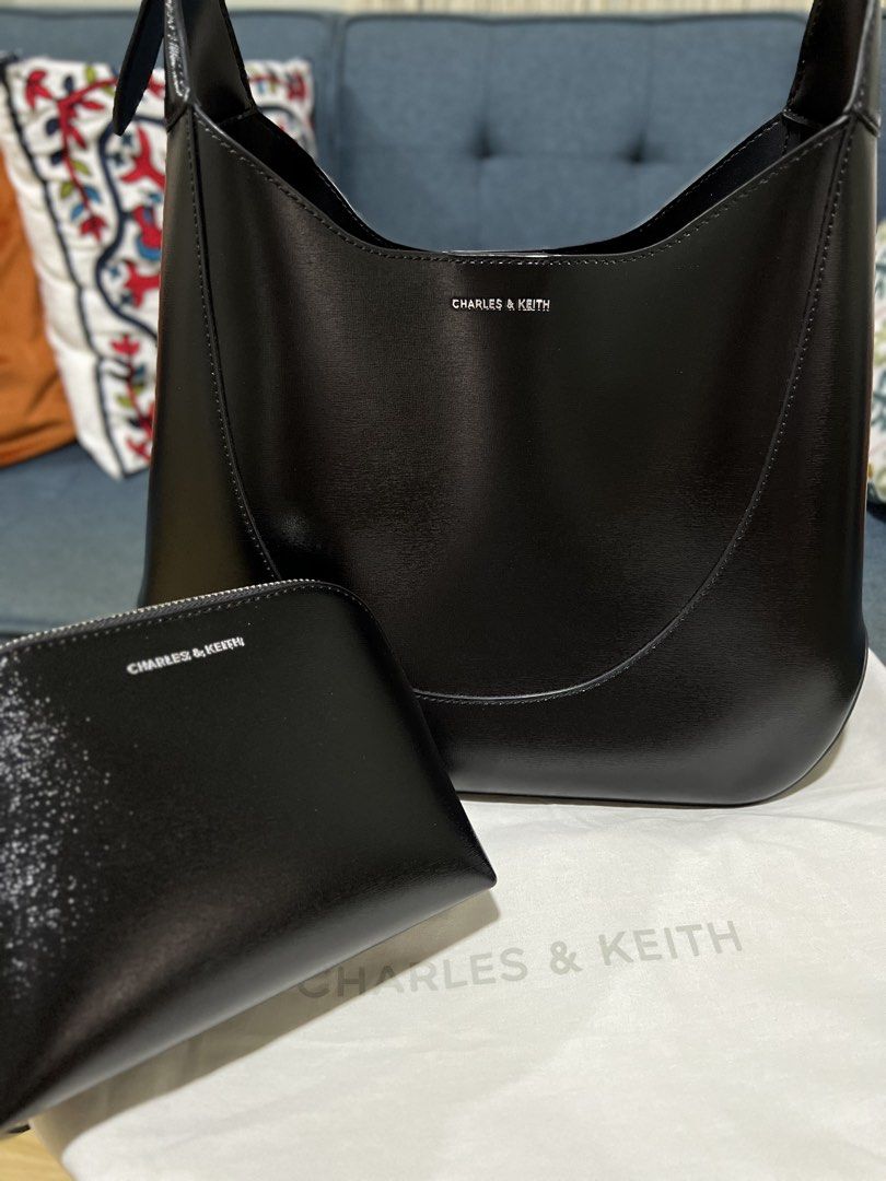 Charles & Keith Black HOBO Bag With Pouch (Category: Shoulder Bags) located in Davao. Submitted by bengscloset (Listing ID 1466649551, Image 2). Description: Brand: Charles & Keith Color: Black Material: Smooth faux leather with silver-tone hardware Details: Structured shoulder bag with magnetic closure & adjustable strap Inclusion: Matching zipped pouch and original dust bag Condition: Excellent, like new 📌 No rush shipping. 📦 Shipping fee c/o
