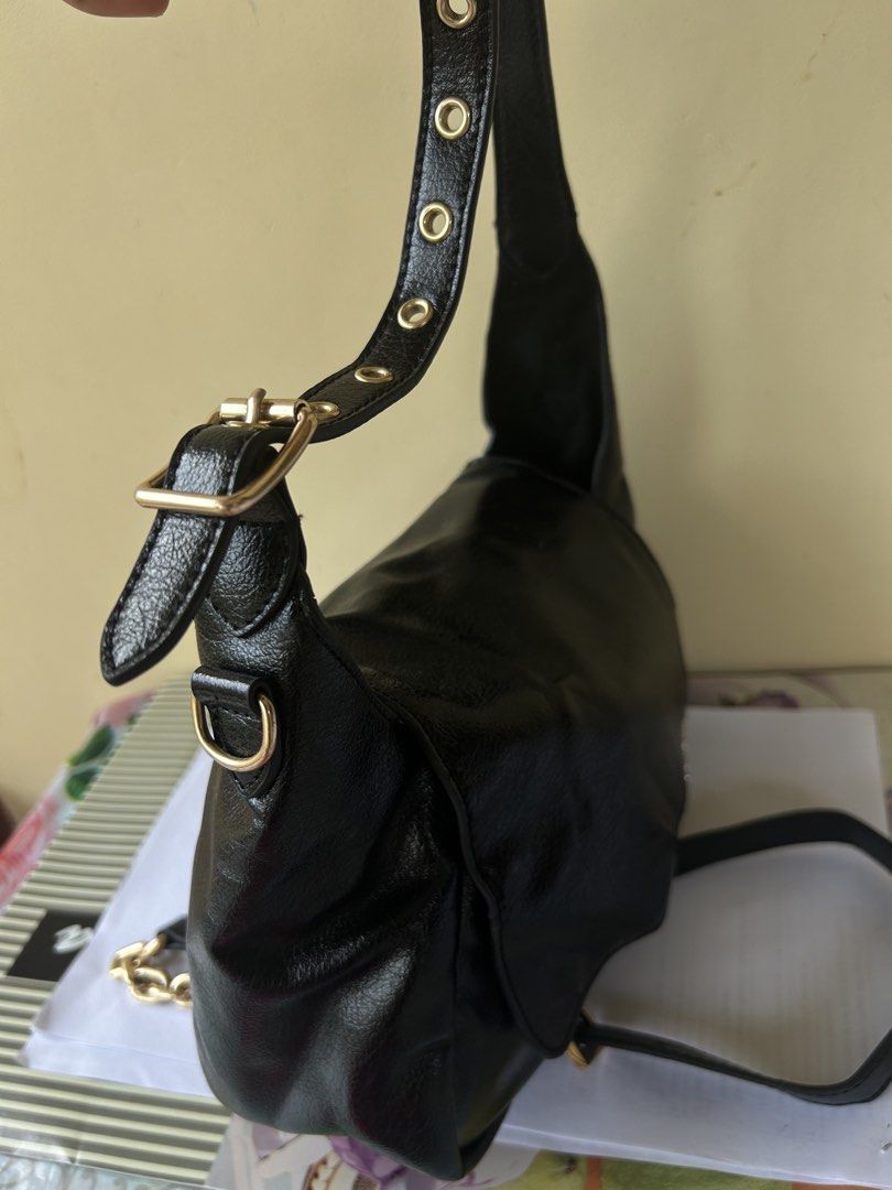 Charles & Keith Black Shoulder Bag with Chain Strap (Category: Shoulder Bags) located in Valencia. Submitted by carmzfindsph (Listing ID 1466684181, Image 2). Description: - Brand: Charles & Keith - Material: Black crinkled faux leather with gold-tone hardware - Closure: Flap with magnetic snap - Handles: Short top handle with gold eyelet details and adjustable buckle - Straps: Includes a removable long strap with a trendy chunky gold chain secti