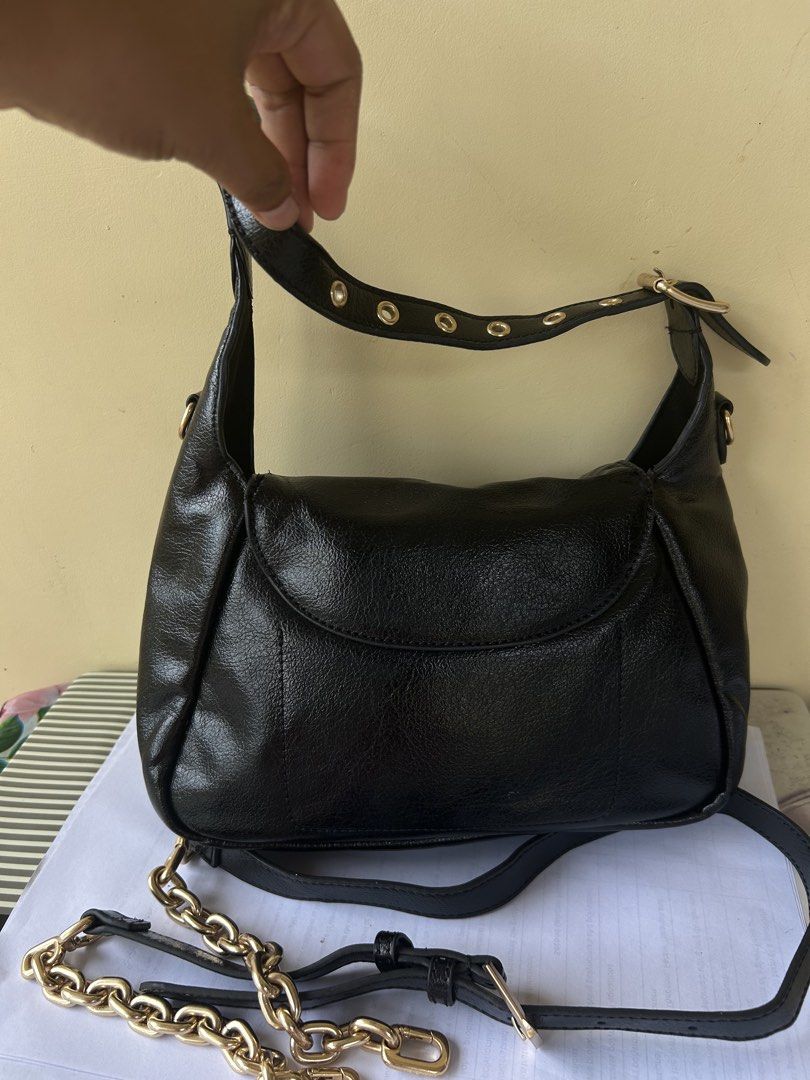 Charles & Keith Black Shoulder Bag with Chain Strap (Category: Shoulder Bags) located in Valencia. Submitted by carmzfindsph (Listing ID 1466684181, Image 3). Description: - Brand: Charles & Keith - Material: Black crinkled faux leather with gold-tone hardware - Closure: Flap with magnetic snap - Handles: Short top handle with gold eyelet details and adjustable buckle - Straps: Includes a removable long strap with a trendy chunky gold chain secti
