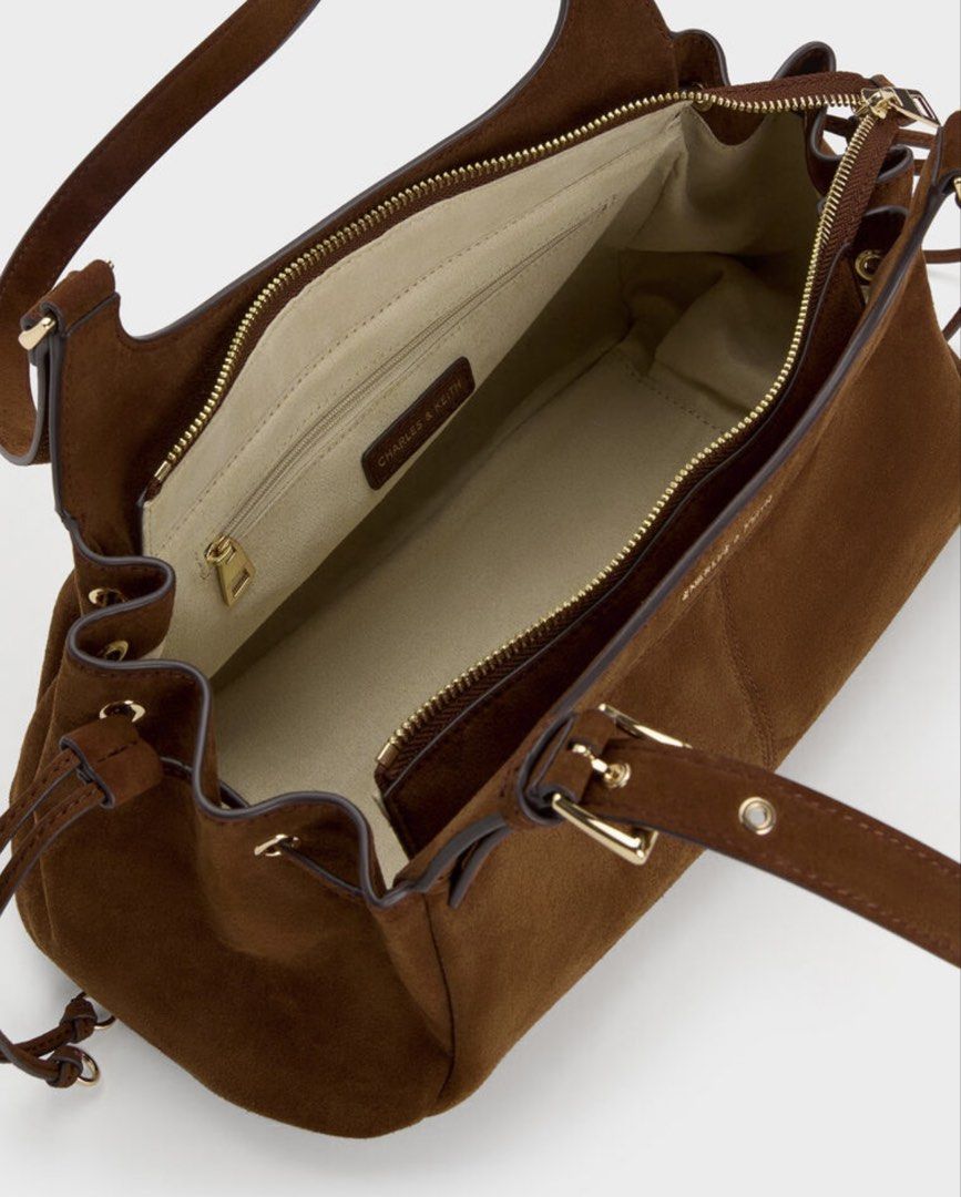 Charles & Keith Lilith Drawstring Tote Bag Pecan Brown (Category: Tote Bags) located in Malabon City. Submitted by tinxoxo (Listing ID 1466594339, Image 2). Description: USED ONCE ONLY SA EVENT. WITH DUSTBAG - Brand: Charles & Keith ORIGINAL - Model: Lilith Drawstring Tote Bag - Color: Rich Pecan Brown - Material: Soft suede with elegant gold-tone hardware - Storage: Spacious main compartment with zipper closure and handy internal pockets - Desig